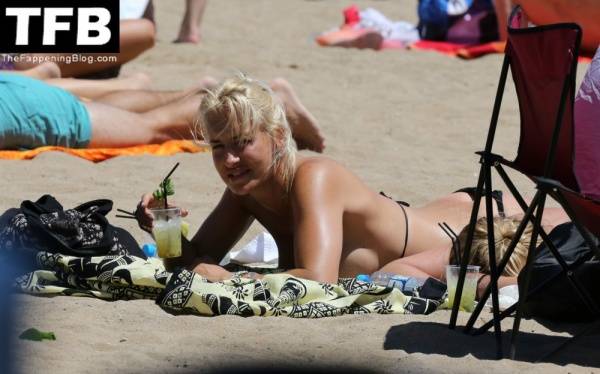 Sarah Connor Flashes Her Nude Breasts on the Beach on solefans.net