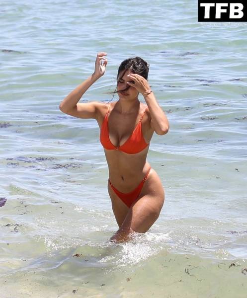 Tao Wickrath Stuns in Small Orange Bikini on the Beach in Miami - county Miami on solefans.net